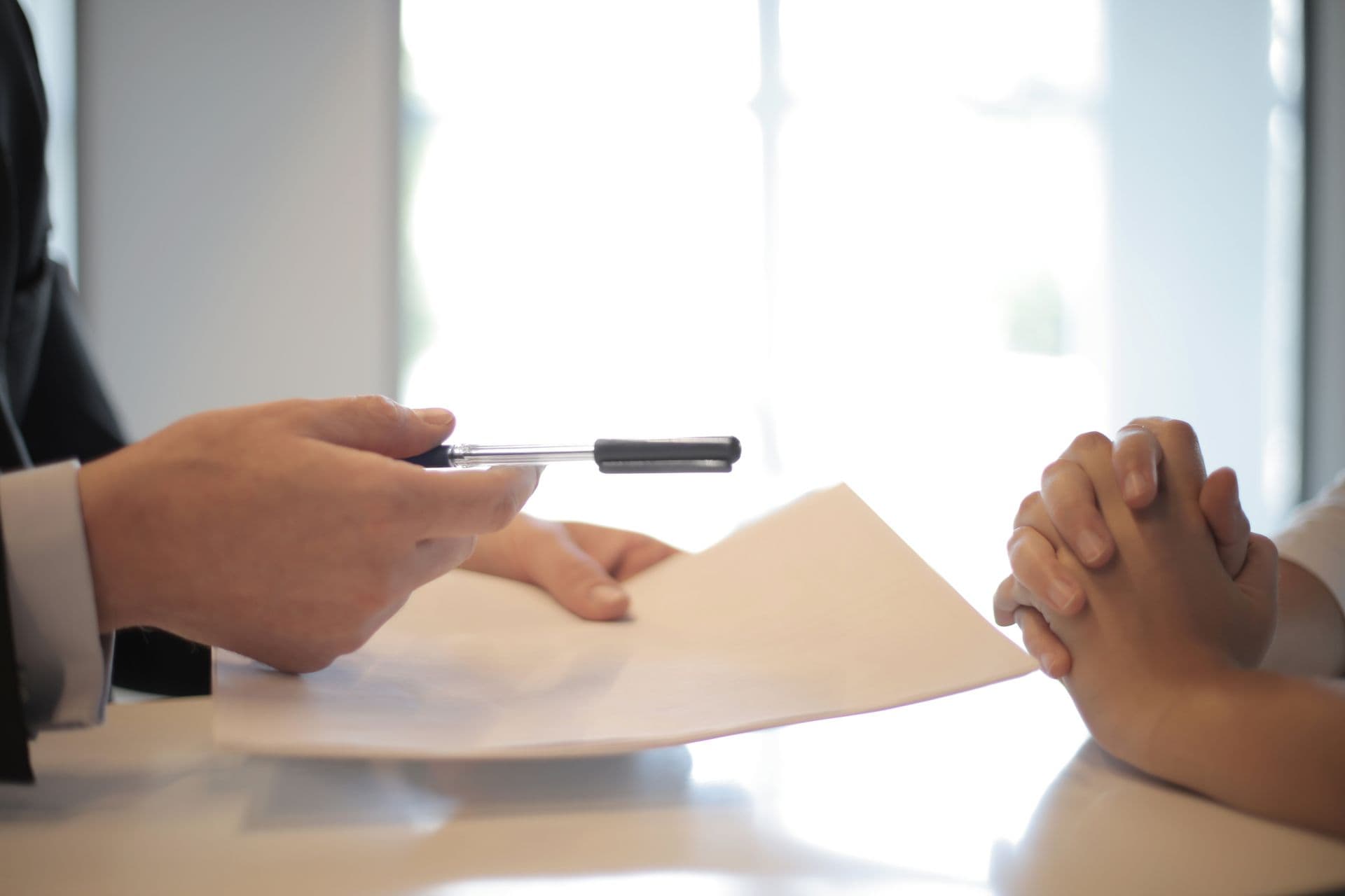 Candidate being handed a pen to sign an offer letter